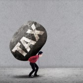 Image of man carrying a large rock with the word, taxes